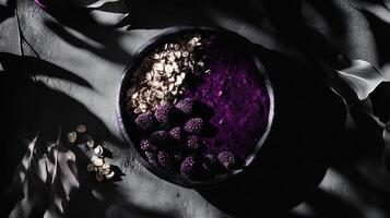 Striking monochrome composition featuring acai and granola against a shadowy background in a minimalist setting photo