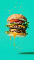 Mega hamburger floating mid-air with vibrant toppings and cheese dripping on bright blue background photo