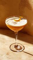 Refreshing lemon drop martini with a citrus twist on a sunlit surface photo