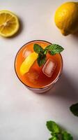 Refreshing turmeric iced tea garnished with lemon and mint on a sunny afternoon in a serene cafe setting photo