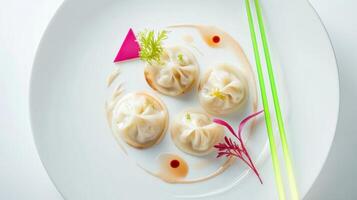 Dumplings served in creamy sauce with vibrant garnishes on an elegant plate photo