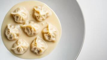 Dumplings in creamy sauce plated on a white dish perfect for a comforting meal photo