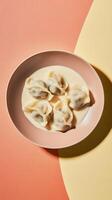 Dumplings served in creamy sauce on a pastel background creating an artful culinary display photo