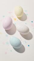 Colorful speckled eggs beautifully arranged on a modern surface, evoking a playful yet elegant atmosphere photo