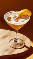 Refreshing limoncello lemon drop martini served in a stylish glass on a wooden surface with a lemon garnish photo
