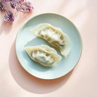 Artfully cut open cabbage and pork dumplings displayed on a minimalist plate with delicate flowers photo