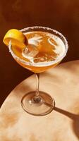 Refreshing lemon drop martini garnished with lemon slice served in elegant glass against warm backdrop photo