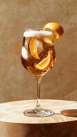 Limoncello spritz served in a stylish glass with citrus garnish and ice on a rustic table photo