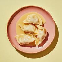 Artfully arranged dumplings in creamy sauce on pastel plate photo