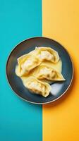 Dumplings in creamy sauce beautifully arranged on a vibrant plate against contrasting backgrounds photo