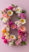 Number 8 made of flowers on pink background photo