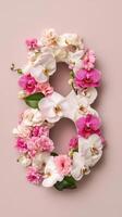 Number 8 made of flowers on pink background photo