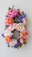 A floral arrangement of flowers is arranged in the shape of the letter b photo