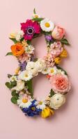 Number 8 made of flowers on pink background photo