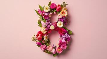 The number eight is made of flowers on a pink background photo