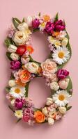 Flowers in the shape of the number 8 on pink background photo