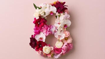 A number eight made of flowers on a pink background photo