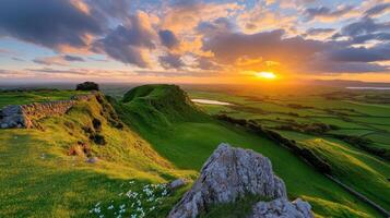 Breathtaking sunset over rolling green hills in Irish countryside with dramatic clouds photo