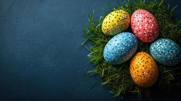 Vibrant decorated eggs nestled in green grass on a colorful background for festive celebration photo