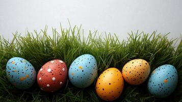 Decorated eggs scattered on vibrant green grass for spring festivities photo
