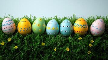 Colorfully decorated eggs resting on lush green grass in a vibrant spring setting photo