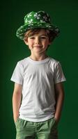 Young boy in a green hat smiling while standing against a vibrant green background photo