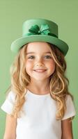 Cheerful young girl in a green hat smiles brightly against a simple green background photo