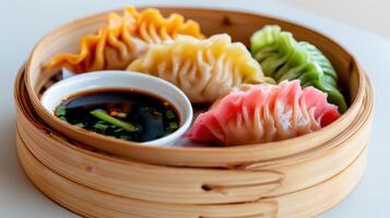 Vibrant assortment of colorful dumplings served with dipping sauce in a bamboo steamer photo