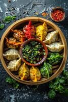 Colorful assortment of vibrant dumplings served with dipping sauce in a wooden steamer photo