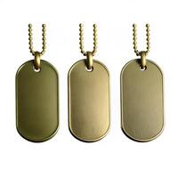 Three GoldColored MilitaryStyle Dog Tags with Ball Chains on White Background photo