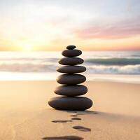 A stack of stones on the beach at sunset photo
