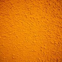 A Detailed Close Up View of a Deep Orange Textured Wall Surface photo