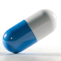 A blue and white pill on a white surface photo