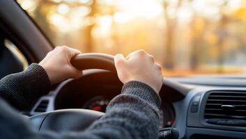 Person driving car in autumn forest. Interior view. Possible stock photo use