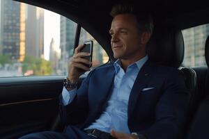 Businessman using smartphone in a car. photo