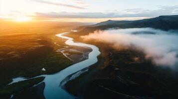 Aerial view of a winding river at sunset, mist in valley. photo