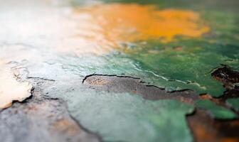 Close-up of peeling paint showing texture and color variations. photo