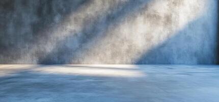 Empty studio room with concrete wall and floor, sunlit. photo