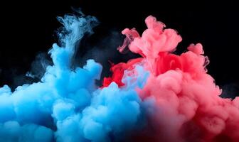 Abstract vibrant colors, blue and pink, ink swirling in liquid, creating a cloud-like, smoky effect against a black backdrop. photo