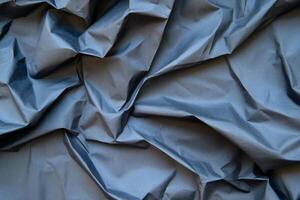 Abstract textured dark gray crumpled fabric background. photo