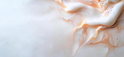 Abstract swirls of cream and peach liquid. photo