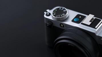 Close-up of a silver digital camera on a dark background. photo