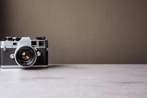 Vintage camera on a table against a neutral background. photo
