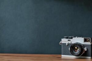 Vintage camera on wooden table against dark background. photo