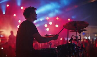 A drummer playing on stage at a concert photo