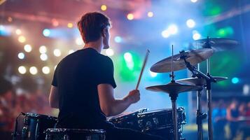 A drummer playing on stage at a concert photo