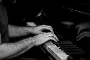 Close-up of man's hands playing piano. photo