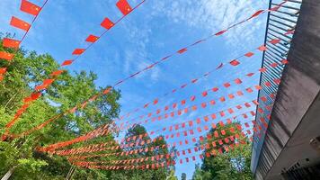 red flags are hanging in the air in front of a building photo