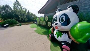 a giant panda bear statue is displayed in front of a building photo