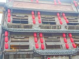 a building with red lanterns hanging from the windows photo